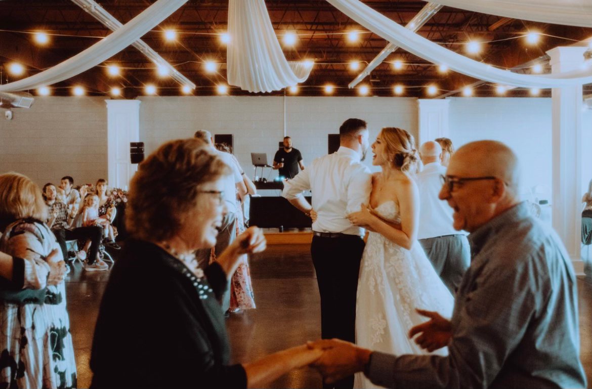 Guests of every age dancing together at a reception.