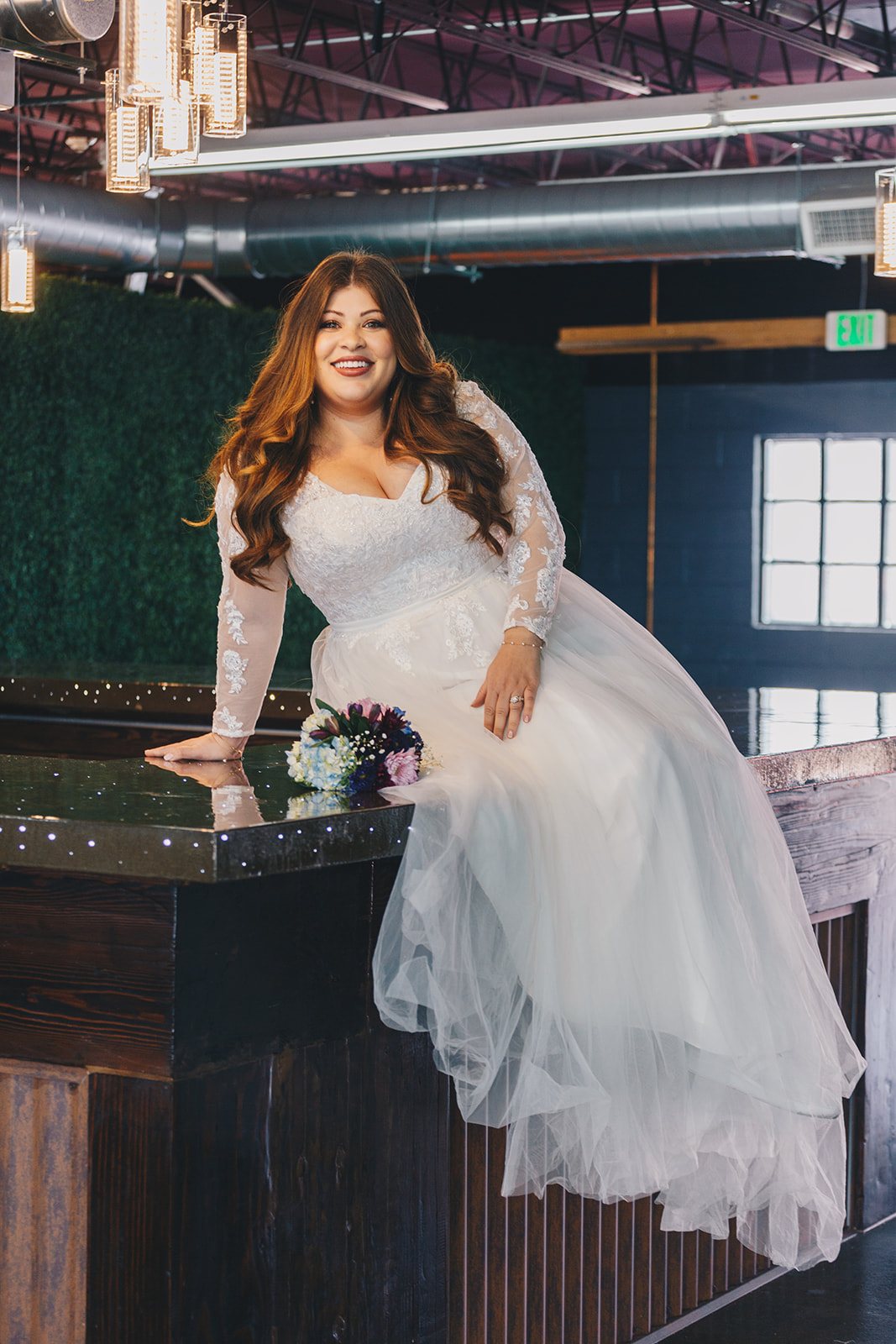 A bride sitting on the Cocktail Room bar.